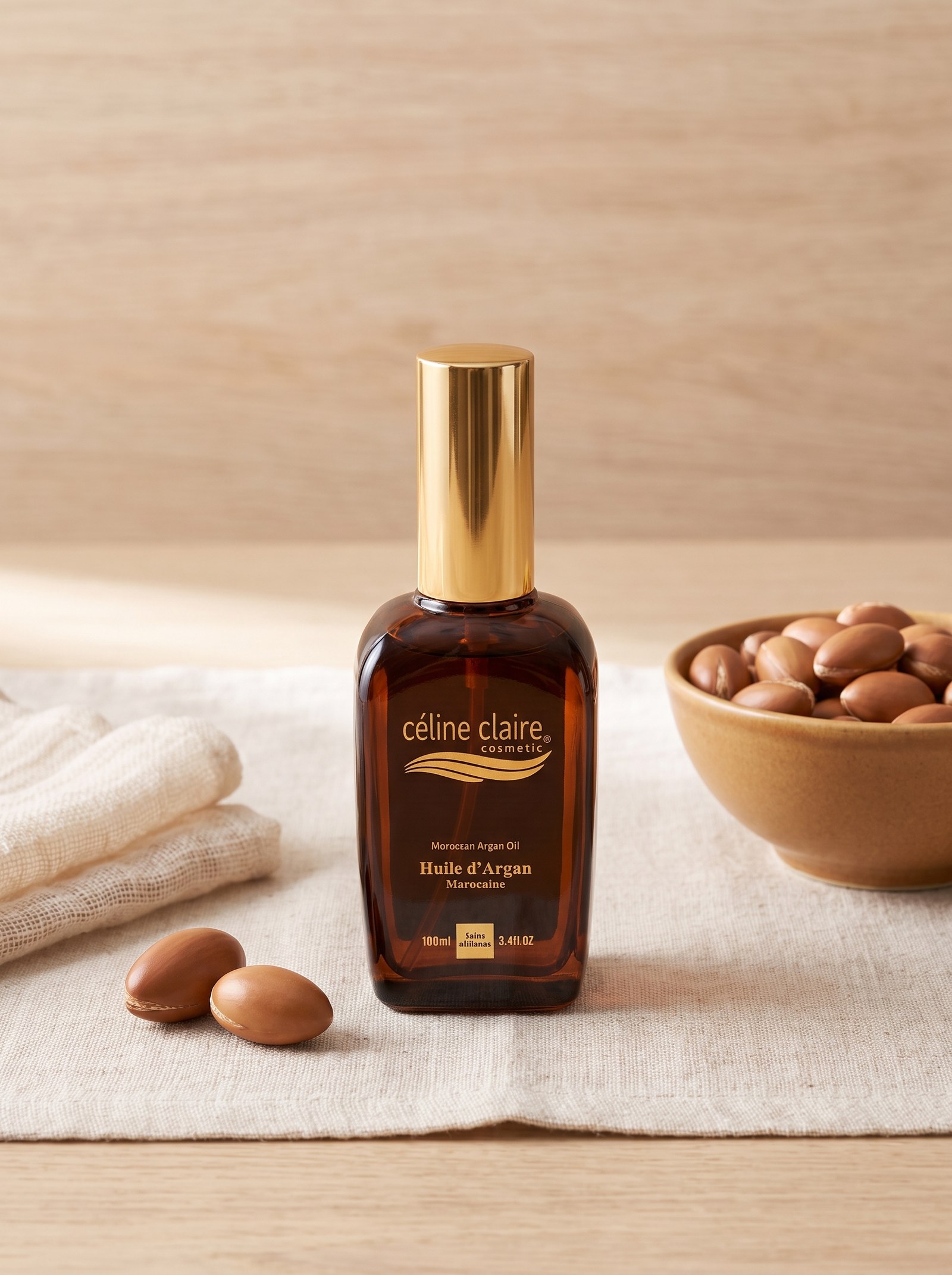 Céline Claire Moroccan Argan Oil bottle beside cracked argan kernels on a cream linen runner