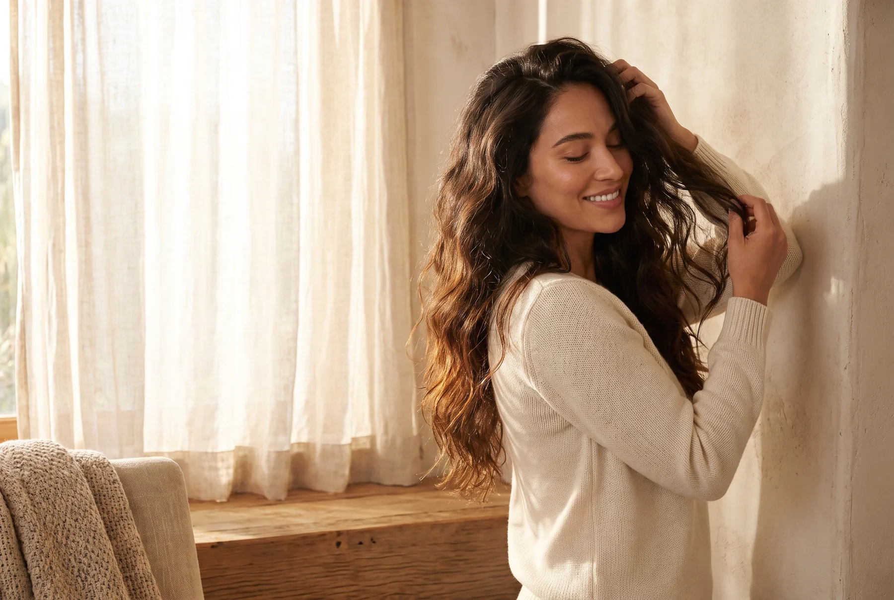 Running fingers through fully dry long dark wavy hair with natural movement