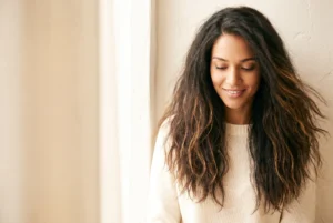 Long dark hair with natural dry-looking texture and soft movement