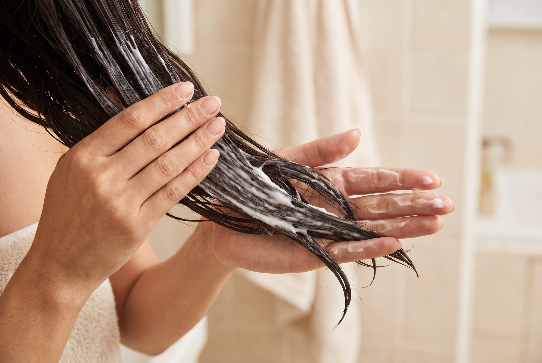 Applying a rich hair mask through damp mid-lengths and ends