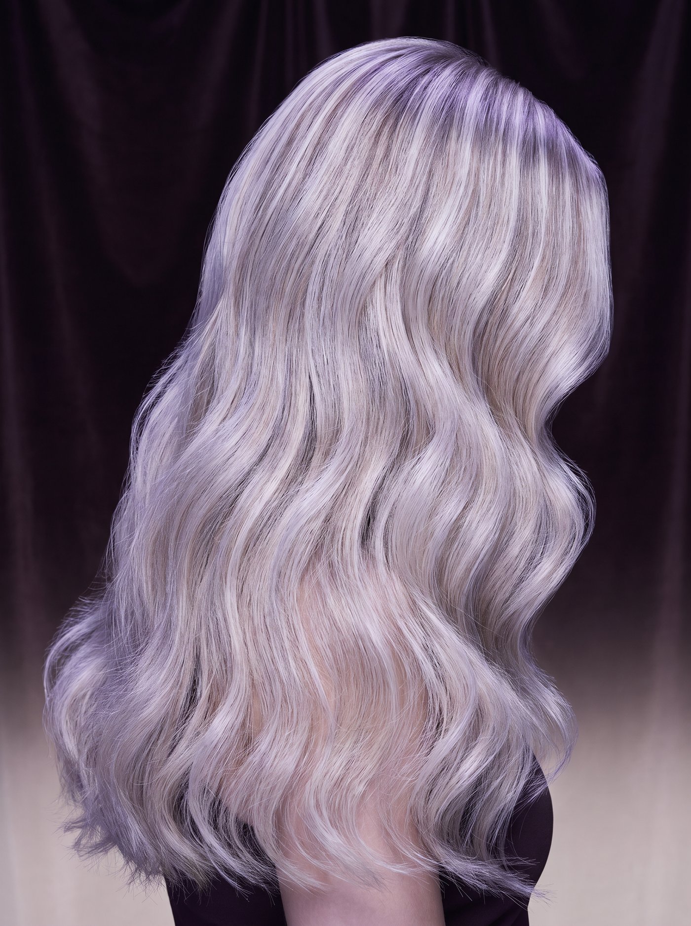 Platinum blonde and silver highlighted hair under restrained cool violet light