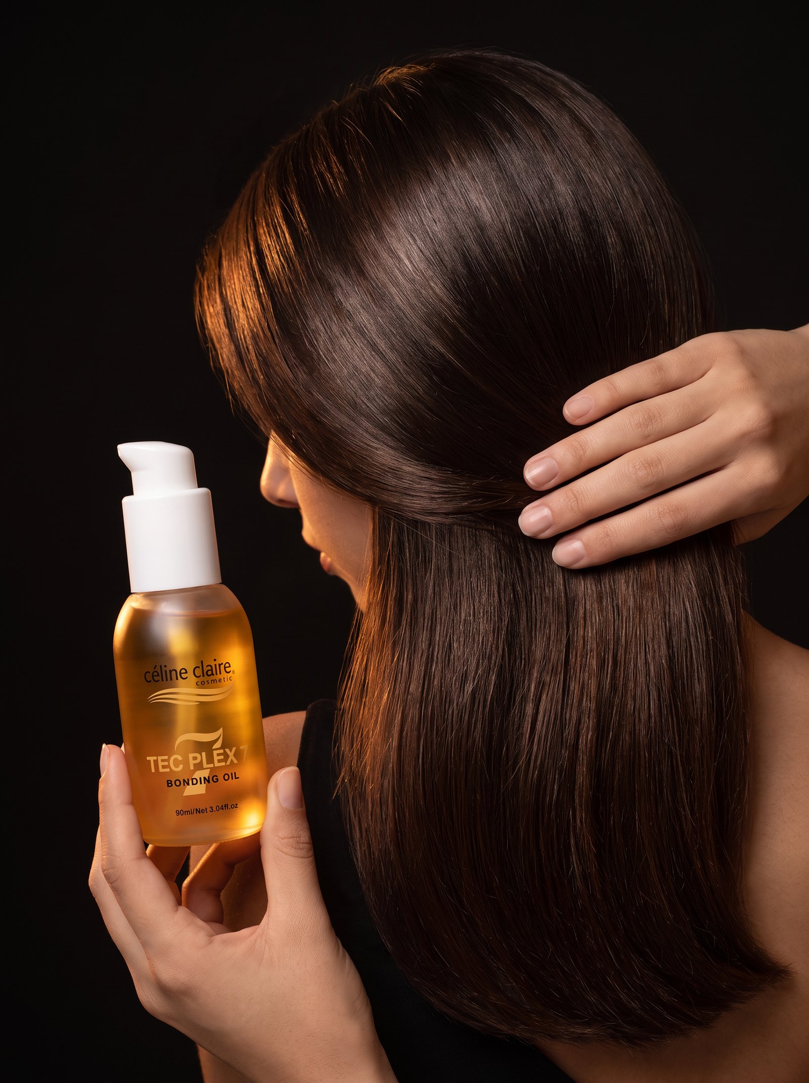 Smoothing a small amount of oil over styled dry hair for polish