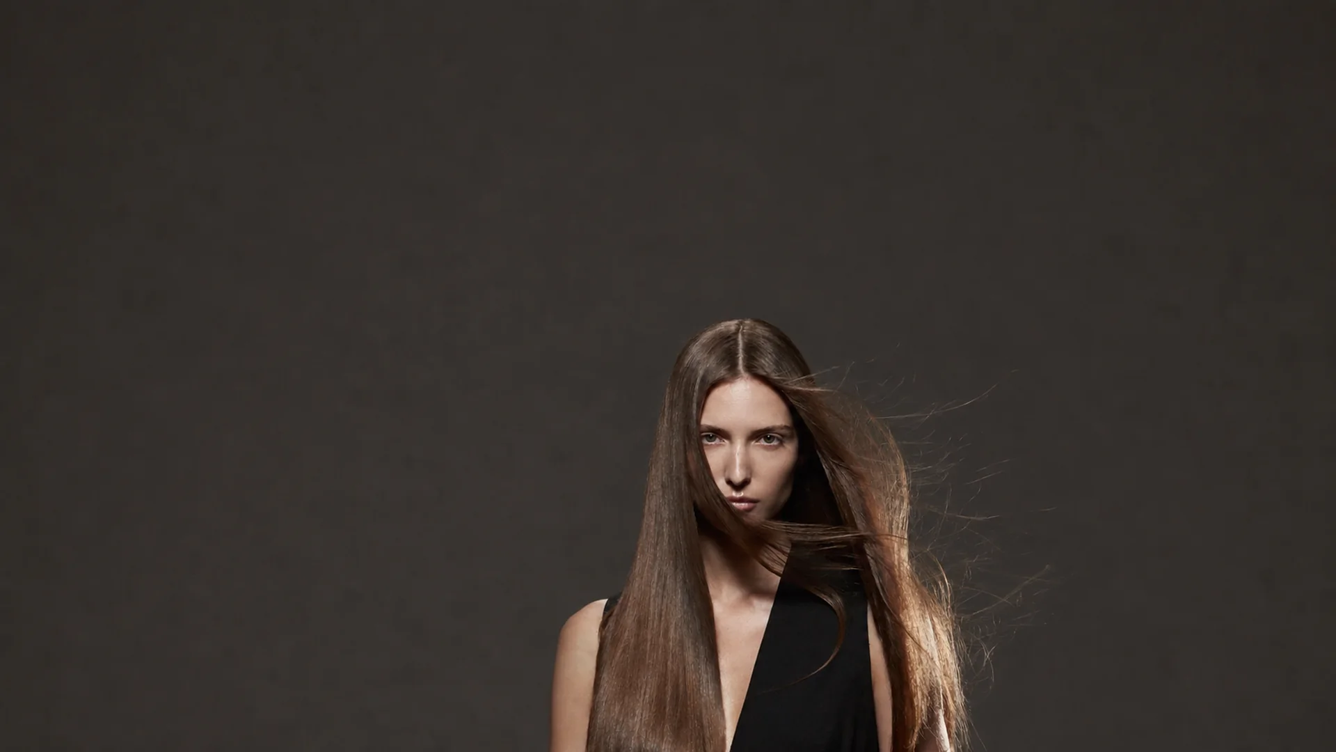 Model with long smooth cool-brown hair for the Celine Claire Repair Routine.