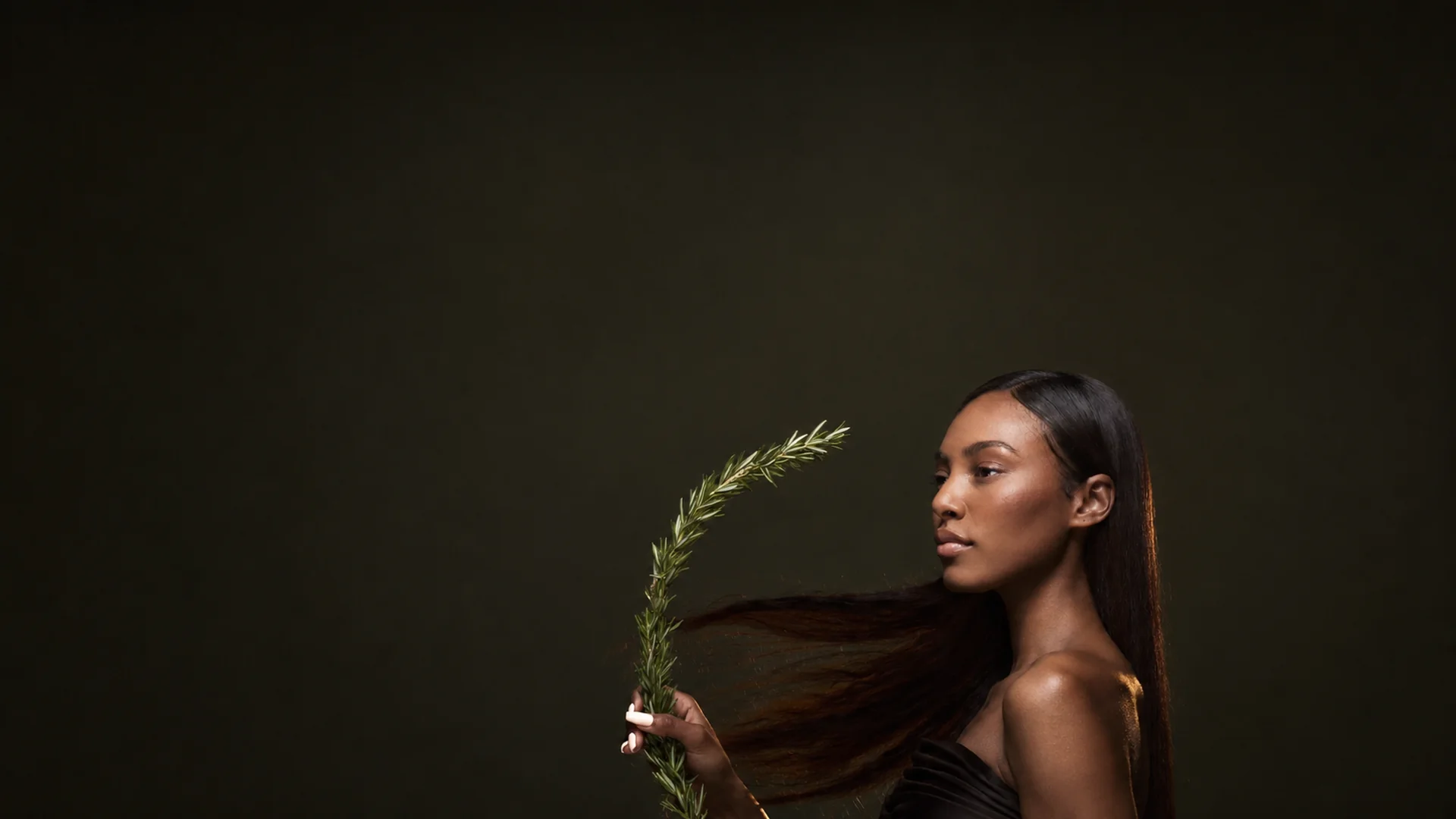 Model with glossy dark hair for the Celine Claire Rosemary Bonding Routine.
