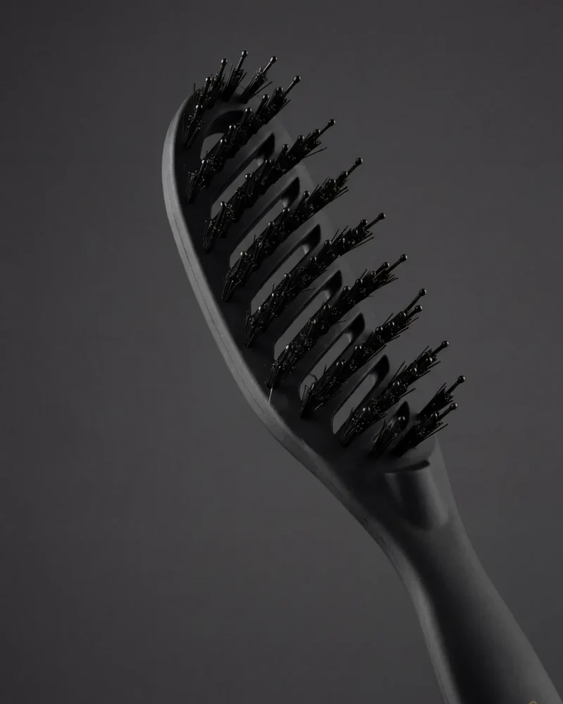 Close view of the Celine Claire Magic Brush bristles and rounded-tip pins